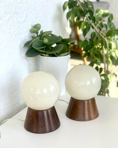 Pair of lamps with wooden bases and globe, 70s